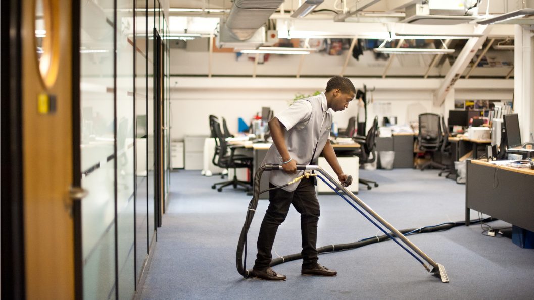 Professional technician vacuuming a commercial workspace during Office Clean Out Services Kent WA